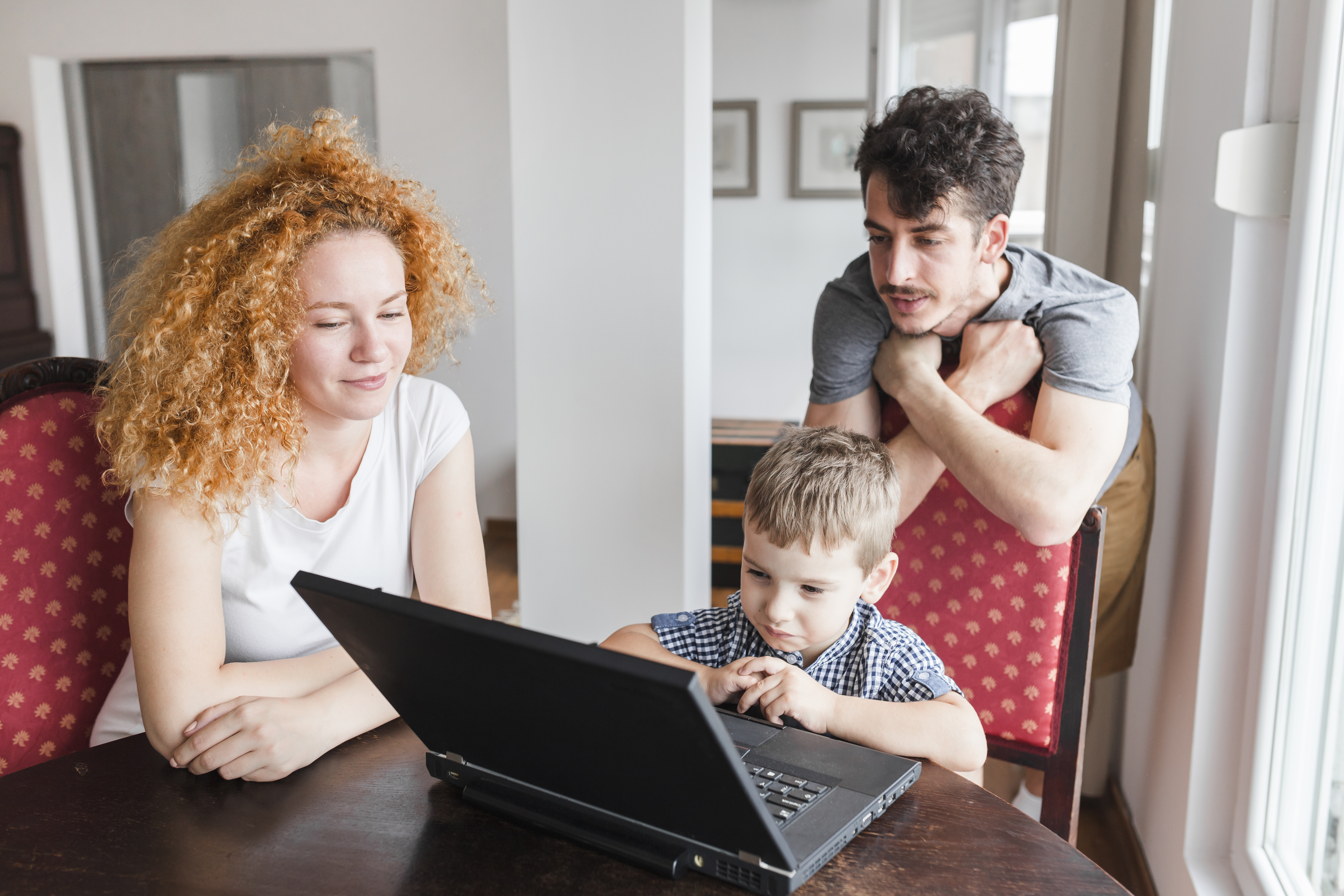 Happy family using laptop safely